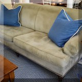 F16. Ultrasuede sofa with nailhead trim. 36”h x 86”w x 38”d 